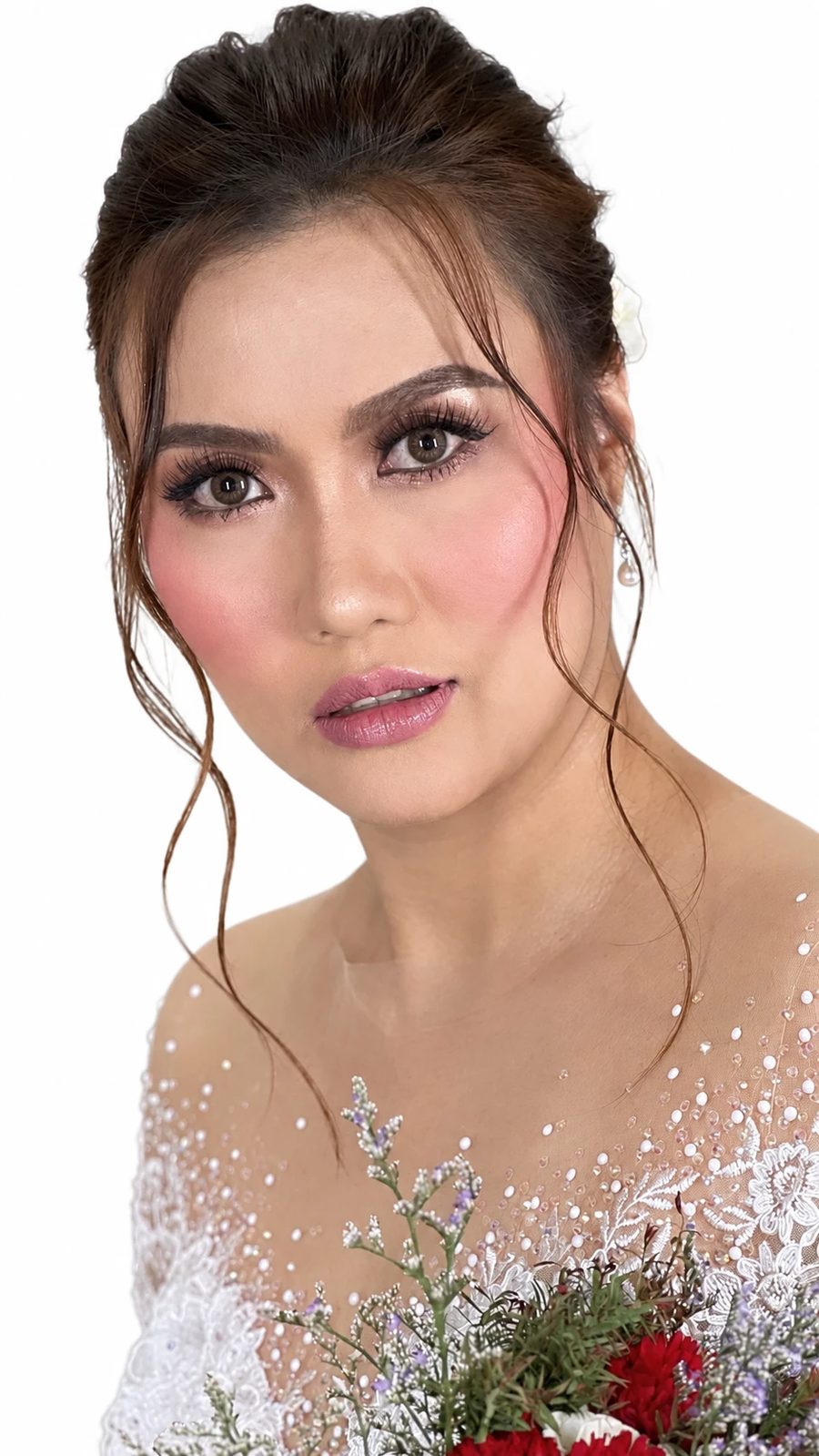 Bride with soft glam makeup, rosy cheeks and a loose updo